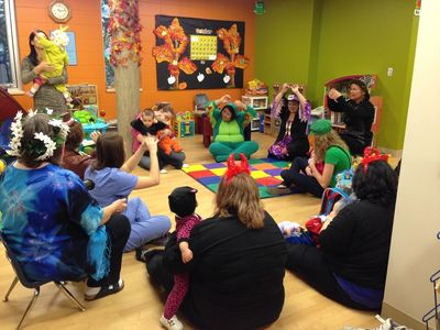 A group of clients and staff sing together in Bethany Hope Centre's Playroom.